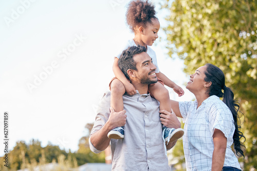 Fotografie Family, love and parents with their daughter in nature, sitting on shoulders in a park during summer