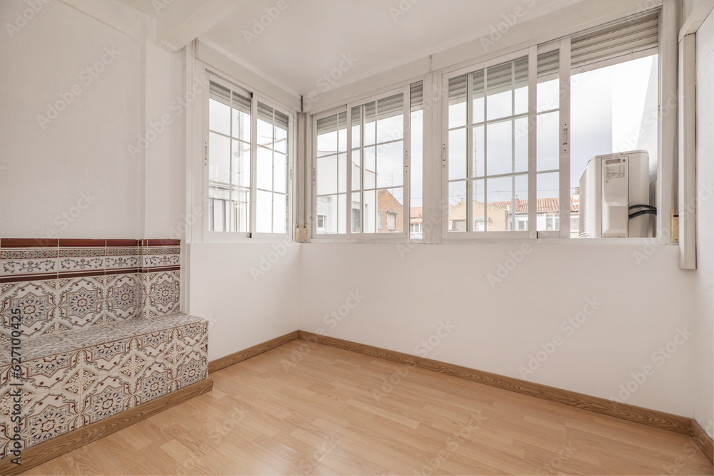Fototapeta premium Enclosed terrace with French-style white aluminum glazing