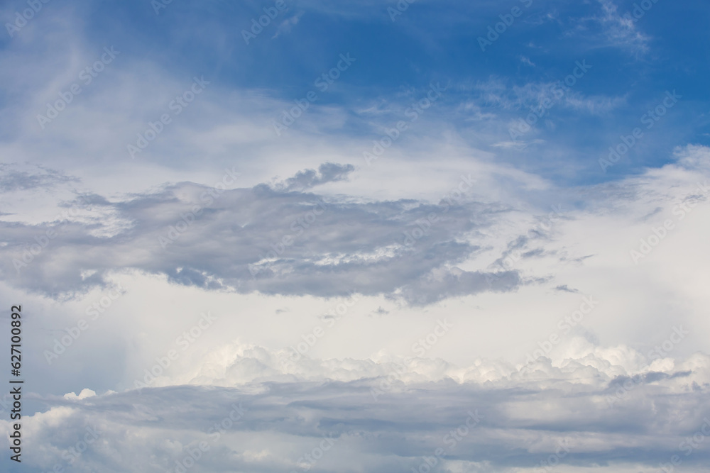 white fluffy clouds standing out against  a blue sky