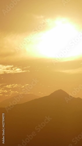 San Gabriel Mountains National Monumant sunrise clouds time lapse telephoto in Los Angeles County California. Vertical view.