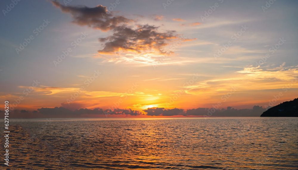 Sunset sky clouds vertical over sea in the evening with colorful orange sunlight reflect on the sea landscape with summer travel concept