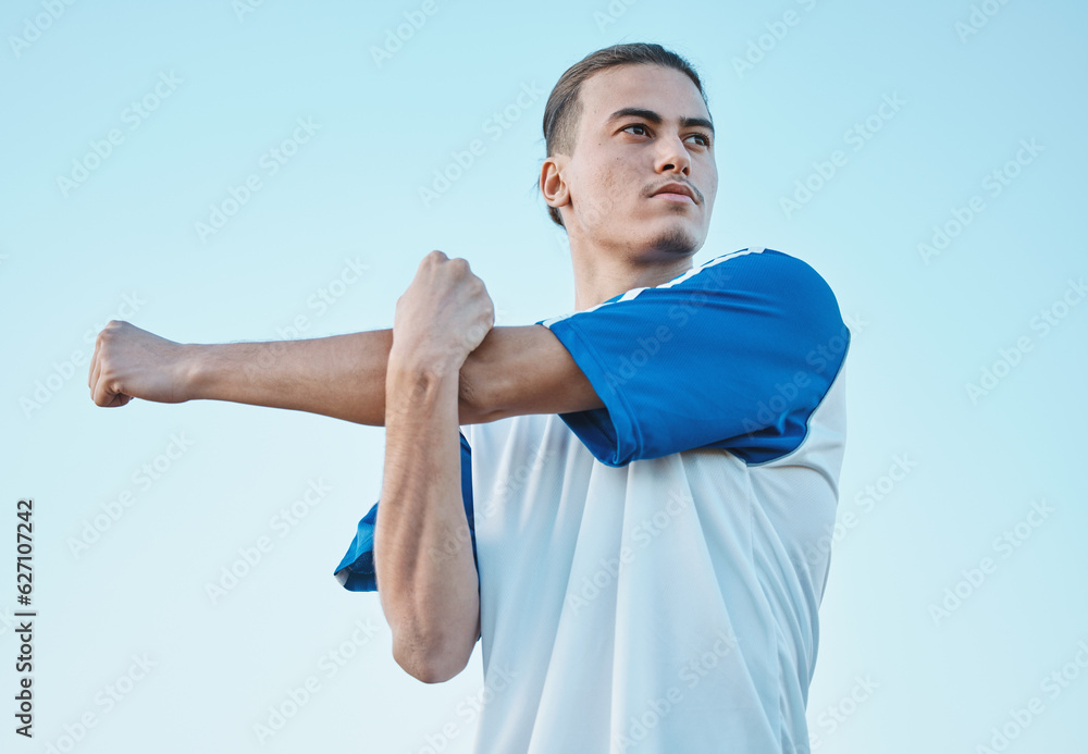 Naklejka premium Soccer, stretching and a sports man on a blue sky background in preparation for a game or competition. Fitness, health and warm up with a young male athlete getting ready for training or practice