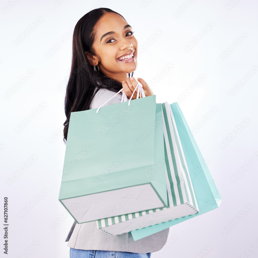 Portrait, woman and bag of shopping in studio, white background and fashion deal in retail package. Happy female customer, gift bags and luxury present from mall, discount market and sales promotion Portrait, woman and bag of shopping in studio, white background and fashion deal in retail package. Happy female customer, gift bags and luxury present from mall, discount market and sales promotion
