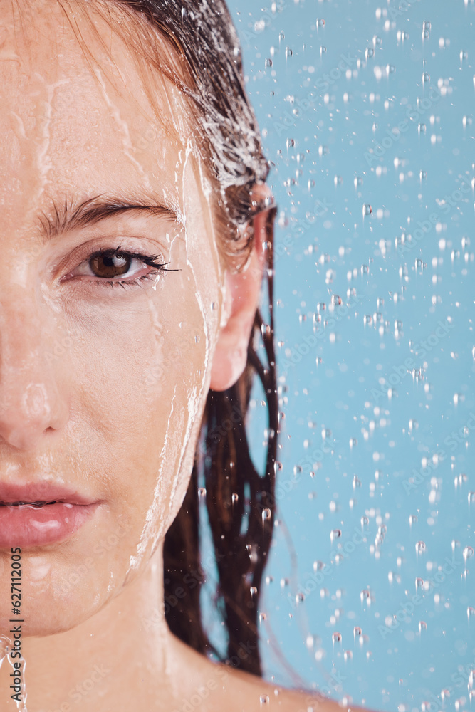 Closeup, portrait and woman with water, shower or hygiene on a blue studio background. Face, female person or model with drops, liquid or aqua for washing, cleaning or morning routine with wellness