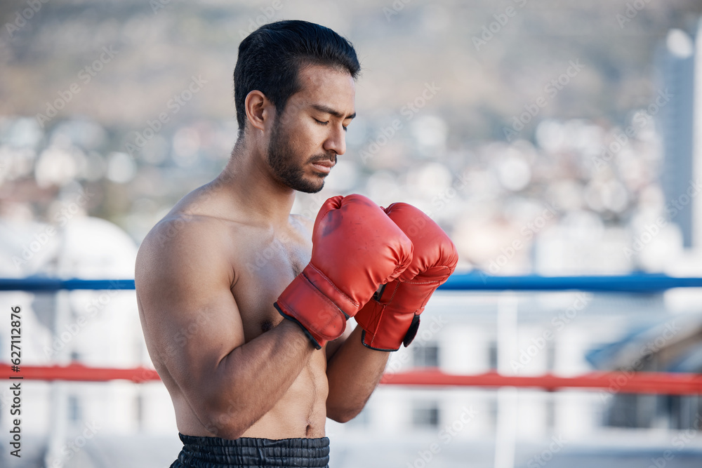 Fitness, boxer praying or man fighting in a ring on rooftop in city for combat training or meditation. Eyes closed, Muay Thai athlete or Asian mma fighter ready for workout, exercise or match battle