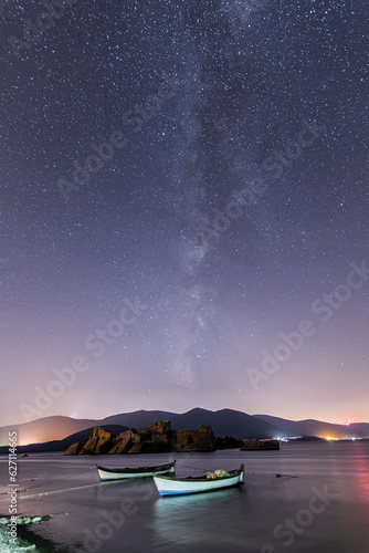 A view of the stars of the Milky Way with a mountain top in the foreground. Night sky nature summer landscape. Perseid Meteor Shower observation