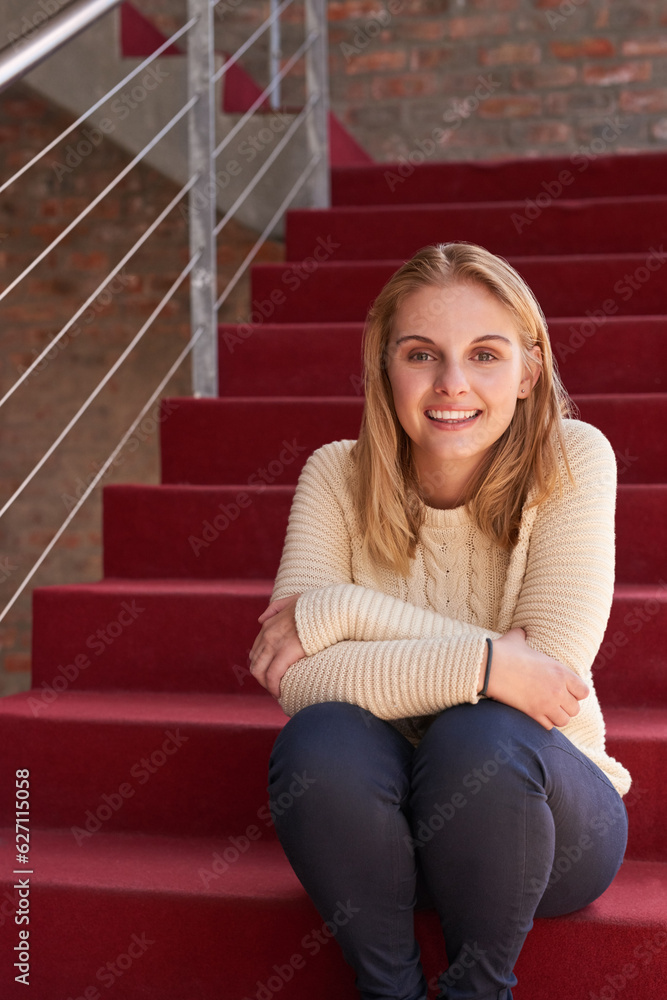 Campus life. Portrait of a university student sitting on a staircase at campus. Campus life. Portrait of a university student sitting on a staircase at campus.