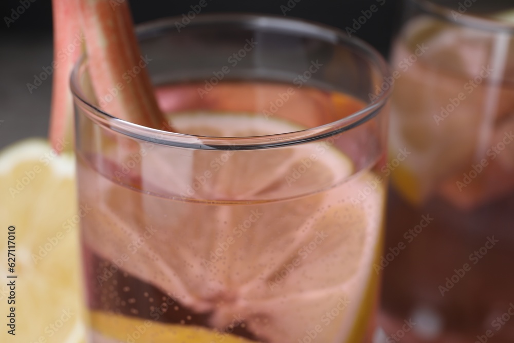 Glass of tasty rhubarb cocktail with lemon, closeup Glass of tasty rhubarb cocktail with lemon, closeup