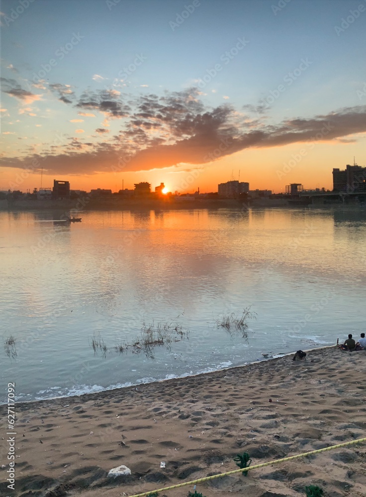 Naklejka premium sunset over the river
