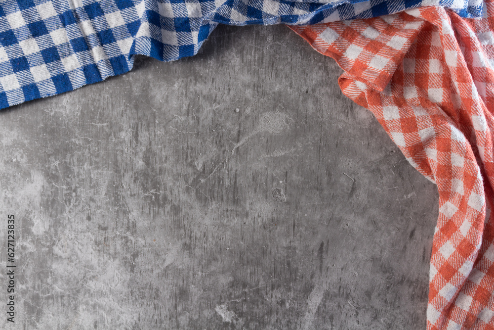 Two checkered tablecloth in a rustic table of concret Two checkered tablecloth in a rustic table of concret