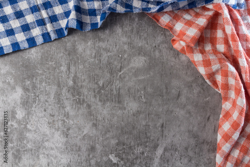 Two checkered tablecloth in a rustic table of concret
