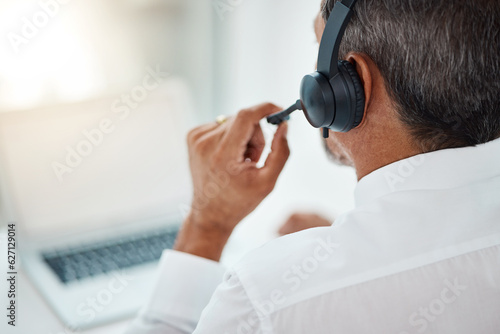 Back, call center and man listening for customer service, support and business with laptop. Contact us, telemarketing microphone and professional, sales agent and crm consultant working at help desk