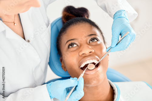 Dentist, black woman and mouth cleaning of patient at a clinic with medical and healthcare for teeth. Mirror, orthodontist and African female person with wellness and dental work tool with care