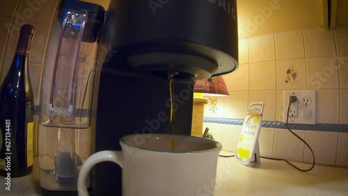 gopro tight but wide  shot of coffee pouring from keurig into mug photo