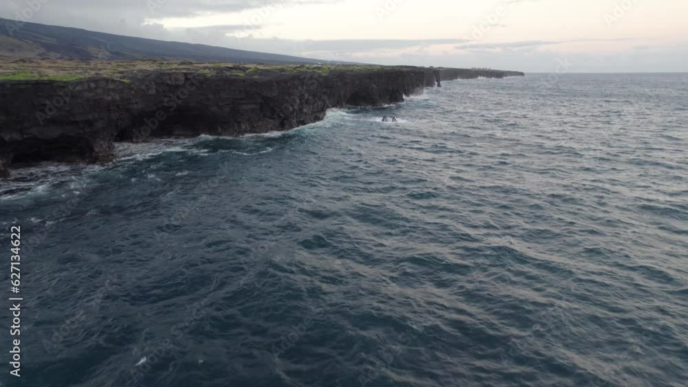 Stunning aerial view of Lava Coast of the Big Island of Hawaii. Ocean waves crushing lava stones from the most active volcano in the world. USA summer travel vacation destination Stunning aerial view of Lava Coast of the Big Island of Hawaii. Ocean waves crushing lava stones from the most active volcano in the world. USA summer travel vacation destination