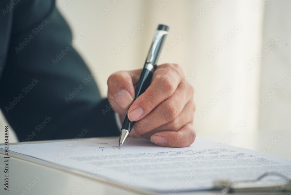 Businessman hand using pen signing on new contract to starting projects in conference room. Close up business manager man hands sign contract legal document in meeting room. Business agreement concept Businessman hand using pen signing on new contract to starting projects in conference room. Close up business manager man hands sign contract legal document in meeting room. Business agreement concept