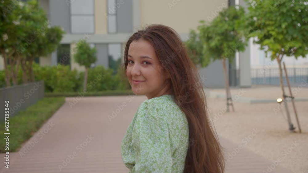 Beautiful girl teen turns around and smiles to the camera, 4k slow mo Beautiful girl teen turns around and smiles to the camera, 4k slow mo