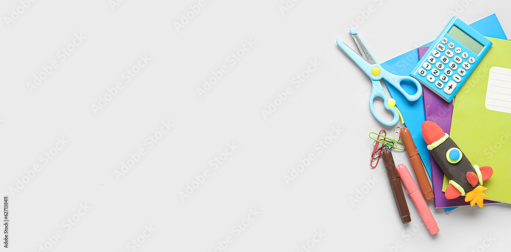 Rocket made of plasticine and stationery on light background with space for text Rocket made of plasticine and stationery on light background with space for text