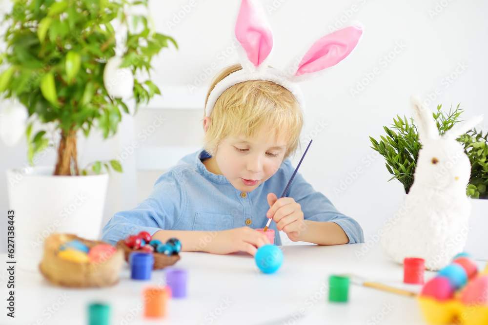 Cute boy paints eggs for Easter holiday. Preparing for celebration is a joy for kids. Cute boy paints eggs for Easter holiday. Preparing for celebration is a joy for kids.