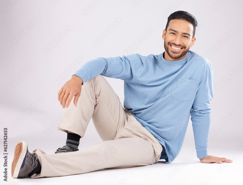 Portrait, fashion and happy man on the floor in studio isolated on a white background. Style, smile and Asian person from Cambodia in casual clothes, trendy aesthetic or confidence to relax on ground Portrait, fashion and happy man on the floor in studio isolated on a white background. Style, smile and Asian person from Cambodia in casual clothes, trendy aesthetic or confidence to relax on ground