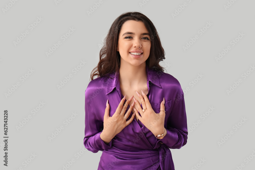 Elegant beautiful young woman with wristwatch on grey background Elegant beautiful young woman with wristwatch on grey background
