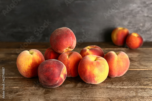 Many sweet peaches on wooden table