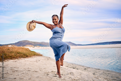 Portrait, excited and black woman dancing, beach and movement with happiness, tropical island or sunset. Face, female person or girl outdoor, travel or seaside holiday for stress relief, dance or joy © Alexis Scholtz/peopleimages.com