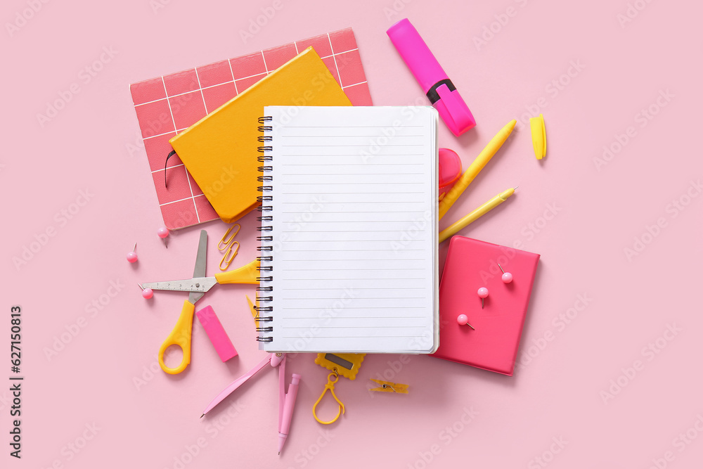 Composition with blank notebook and different school stationery on pink background Composition with blank notebook and different school stationery on pink background