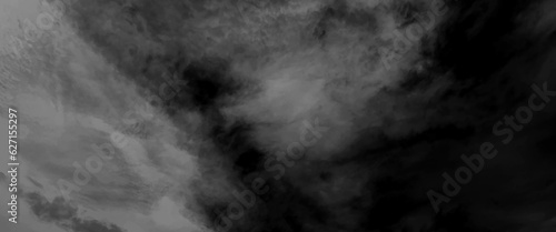 Dark dramatic sky with black stormy clouds before rain or snow as abstract background, dramatic dark storm rain clouds black sky background, dark thunderstorm clouds rainny atmosphere.