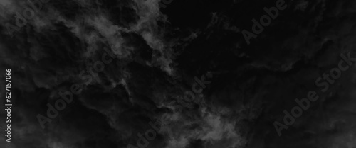 Dark dramatic sky with black stormy clouds before rain or snow as abstract background, dramatic dark storm rain clouds black sky background, dark thunderstorm clouds rainny atmosphere.