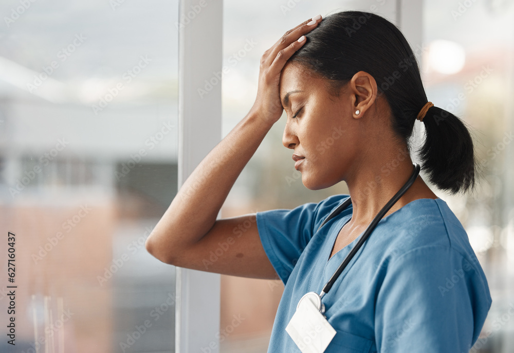 Mental health, doctor with headache and stress standing at window at hospital. Burnout or overworked, anxiety or depression and female nurse or caregiver holding her head for migraine pain at clinic Mental health, doctor with headache and stress standing at window at hospital. Burnout or overworked, anxiety or depression and female nurse or caregiver holding her head for migraine pain at clinic