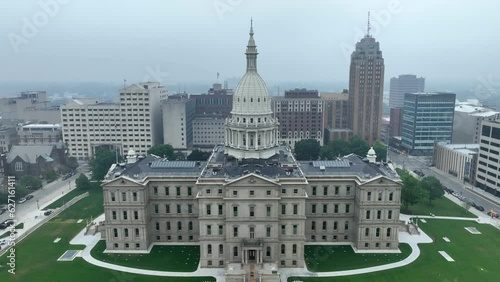 Capitol building of Michigan during dangerous air quality. Aerial establishing shot of government building in capital city of Lansing, MI. Poor air and pollution in Michigan theme. photo