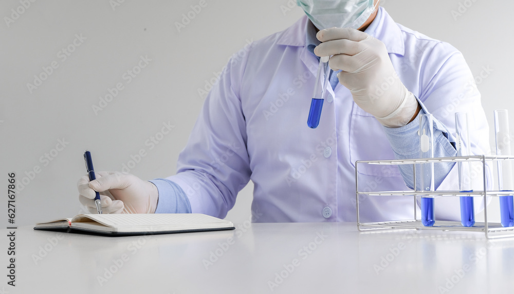 Science innovative Male medical or scientific laboratory researcher performs tests with blue liquid in laboratory. equipment science experiments technology Coronavirus Covid-19 vaccine research Science innovative Male medical or scientific laboratory researcher performs tests with blue liquid in laboratory. equipment science experiments technology Coronavirus Covid-19 vaccine research