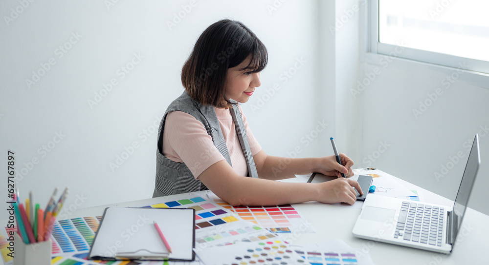 Designer using laptop to design fashion clothes. Designer using laptop to design fashion clothes.