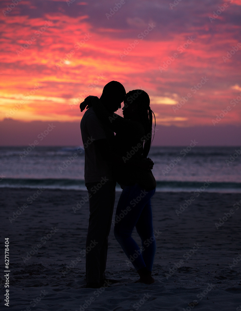 Couple, sunset and silhouette outdoor at the beach with love, care and commitment. Romantic man and woman hug or affectionate on vacation, holiday or nature travel adventure with sunrise sky on date