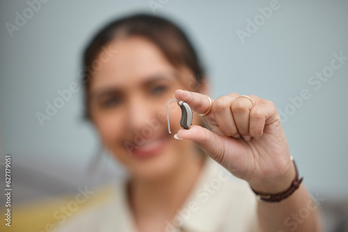 Hearing aid  hands and person with disability for medical support  listening and healthcare innovation. Closeup of deaf female patient with audiology implant to help sound waves  amplifier and volume