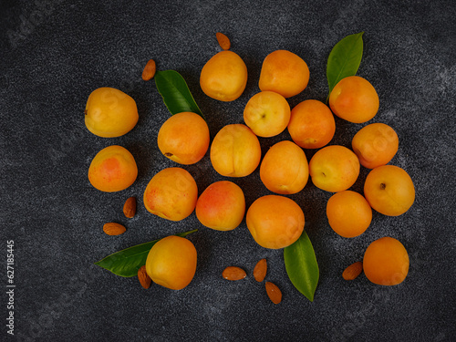Delicious ripe apricots on black background, close-up.