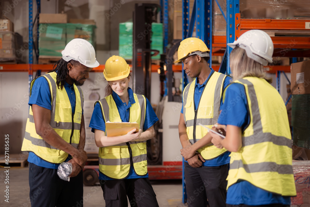 Side view of warehouse workers discussing inspecting goods brought into the warehouse for pre-stocking. Side view of warehouse workers discussing inspecting goods brought into the warehouse for pre-stocking.