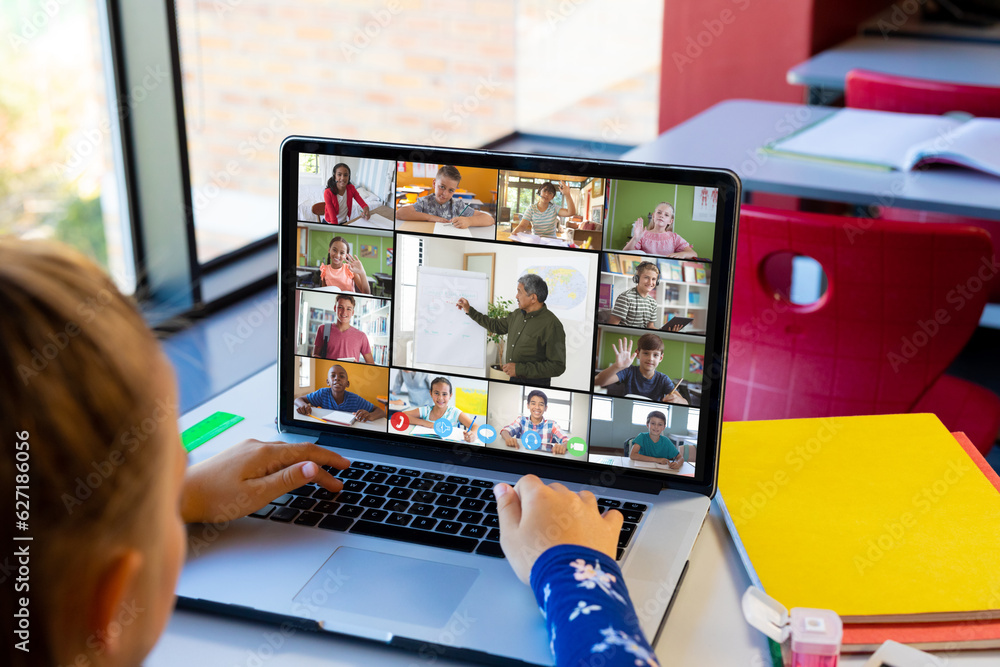 Caucasian girl having a video conference with male teacher and diverse students on laptop Caucasian girl having a video conference with male teacher and diverse students on laptop