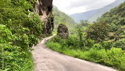 Mountain road between rocks in the Himalayas. Green jungle. Road in the mountains. Wild nature. Mountain View. photo