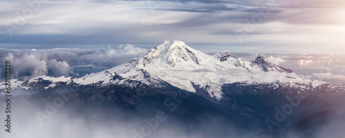 Mt Baker covered in snow and clouds. Aerial landscape nature background.