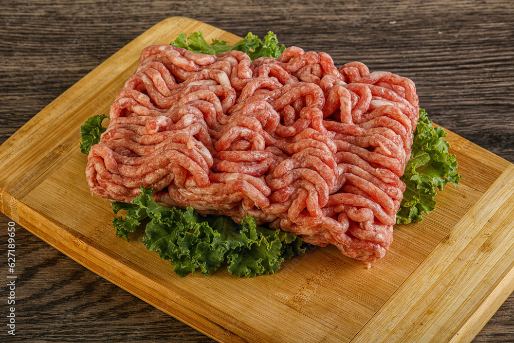 Raw pork minced meat over board Raw pork minced meat over board
