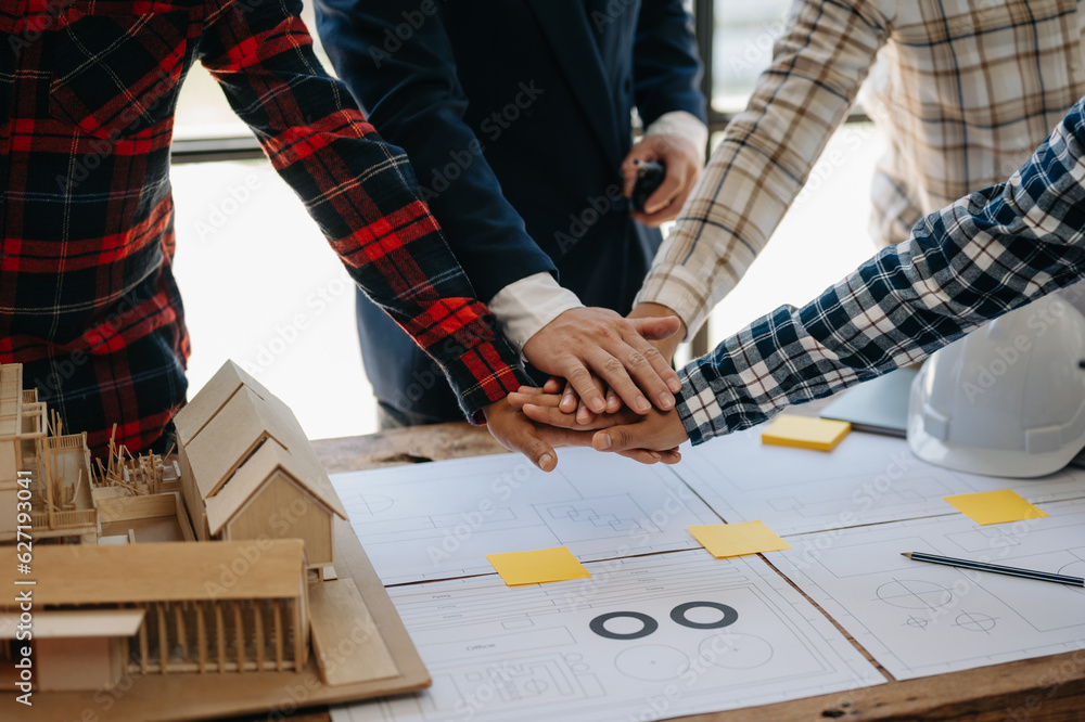 Engineer and contractor join hands after signing contract,They are having a modern building project together. successful cooperation concept. Engineer and contractor join hands after signing contract,They are having a modern building project together. successful cooperation concept.