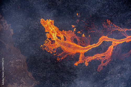 Fototapeta Aerial view of spreading melted lava from volcano.