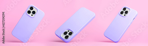 set of three iPhone 15 and 14 Pro max in purple silicone case falling down in different angles, back view isolated on pink background, phone case mockup photo