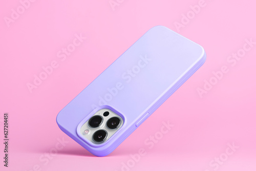 smart phone in purple soft silicone case falls down back view, iPhone 15 and 14 Pro Max case mockup isolated on pink background