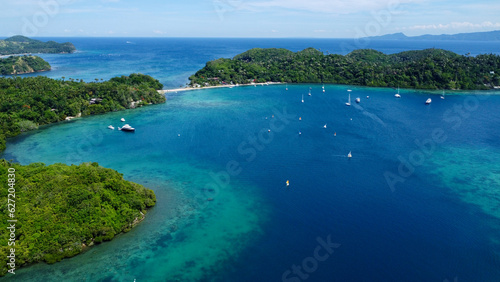 Tropical islands in the Pacific Ocean. Aerial view of the islands  beach and boats in the bay.