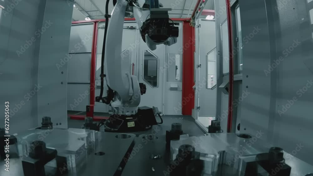 Automated Robotic Arm Picks Up Mechanical Component To Place It On Assembly Line. Modern Automated Robotic Arm Handling Mechanical Component. Automated Robotic Arm At Industrial Factory. Technology Automated Robotic Arm Picks Up Mechanical Component To Place It On Assembly Line. Modern Automated Robotic Arm Handling Mechanical Component. Automated Robotic Arm At Industrial Factory. Technology