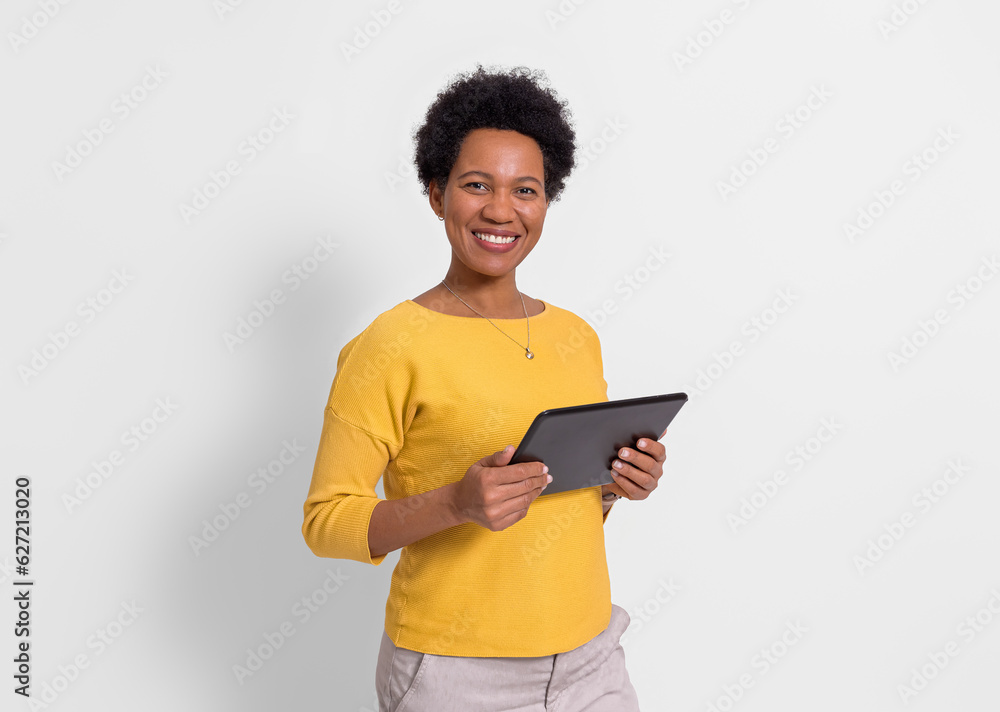 Portrait of smiling young businesswoman holding digital tablet and standing over white background Portrait of smiling young businesswoman holding digital tablet and standing over white background
