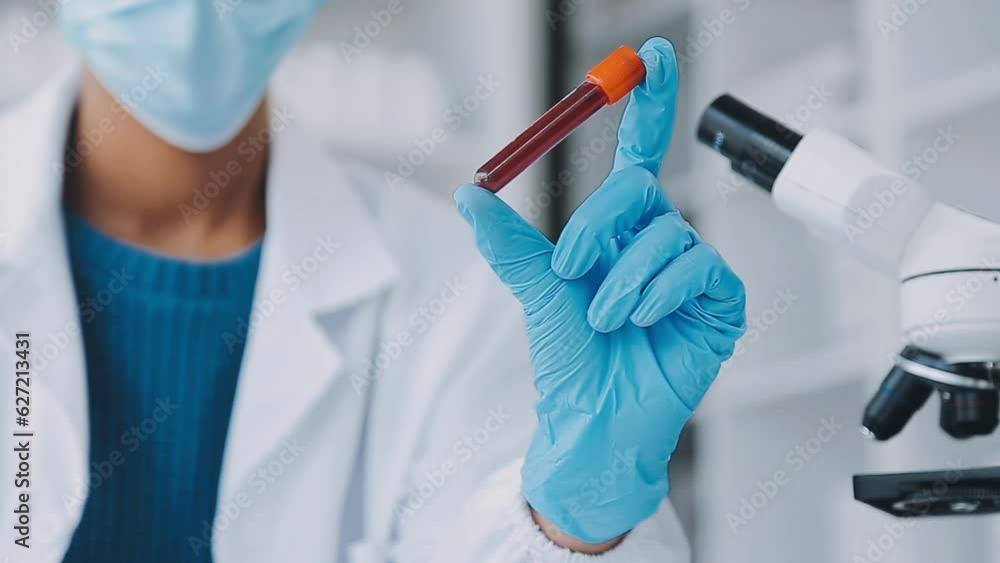 biochemical research scientist team working with microscope for coronavirus vaccine development in pharmaceutical research labolatory, selective focus biochemical research scientist team working with microscope for coronavirus vaccine development in pharmaceutical research labolatory, selective focus